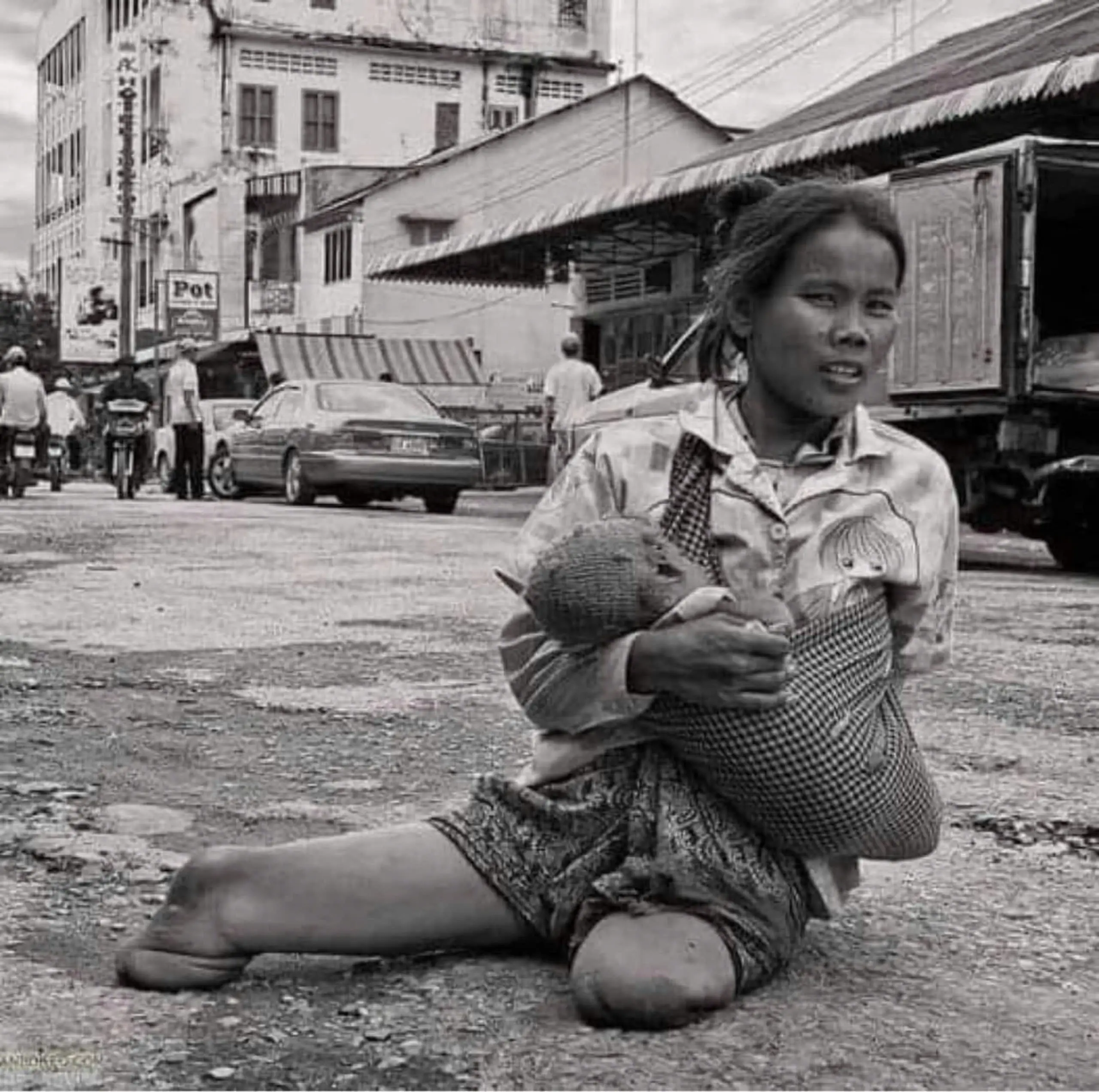 Touching Image of Disabled Mother Holding Child Begging for Compassion and Support